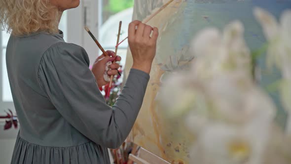 Woman Artist of Drawings Preparing to Create a Abstract Painting Image alt