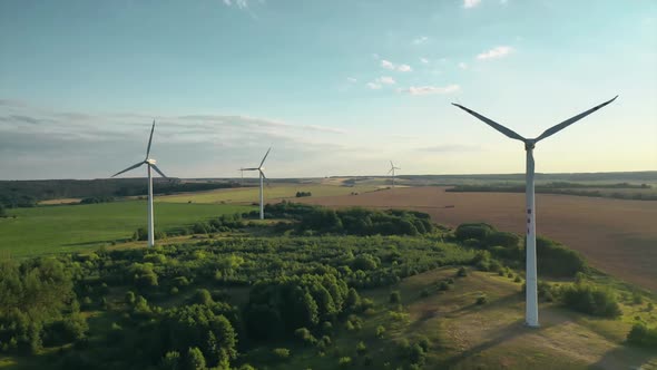 wind generators on the background of the setting sun top view from a drone