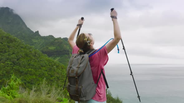 Winner Win Success Concept Happy Tourist Holding Up Hiking Poles in Slow Motion alt