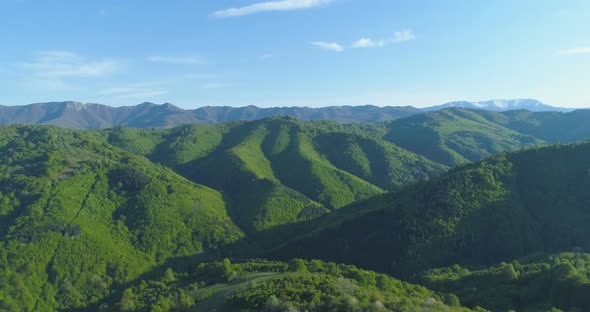 Aerial View of Rolling Green Hills and Forests