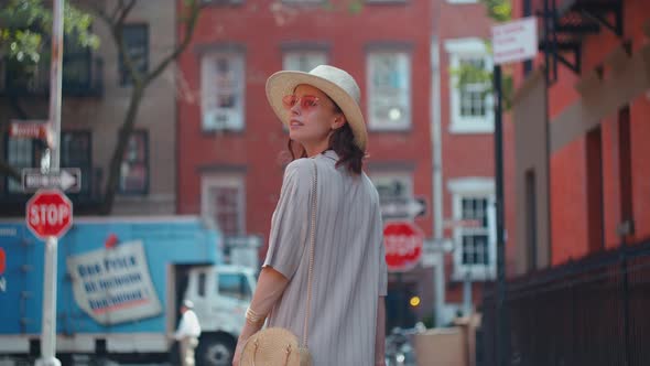 Attractive girl turning around on a street in New York alt