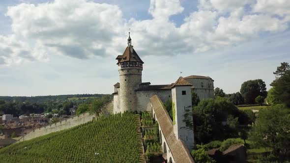 Aerial dolly in of Munot circular fortress and tower on a verdant hill revealing picturesque Schaffh alt
