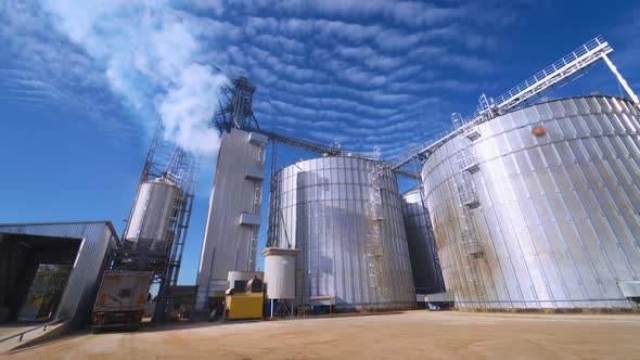 Large Grain Bins. Modern Granary elevator. Agribusiness. alt