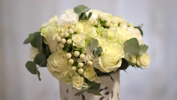 Beautiful wedding bouquet of the bride rotates on a light background.