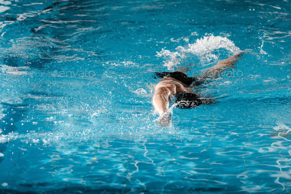 athletic man diving in swimming pool with blue water - Stock Photo - Images