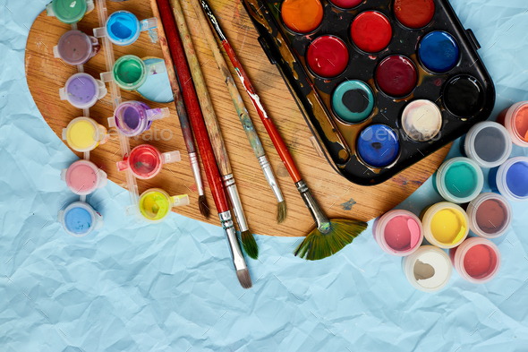 Flat lay of colorful paints, painting palette and brushes - Stock Photo - Images
