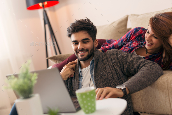 Couple surfing the net on a laptop computer - Stock Photo - Images