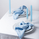 Blu linen napkins and blu candles on the white table - PhotoDune Item for Sale