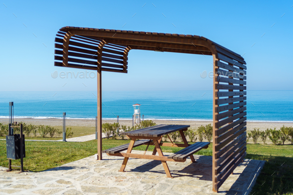 Scenic view of empty rest area near sandy shore beach ocean sea. Landscape of rest place picnic