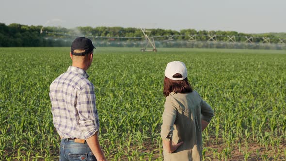 Two Farmers Discuss Irrigation System alt