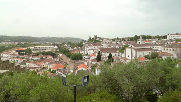 Town and Defensive Wall of Castle of Óbidos on Cloudy Spring Day
