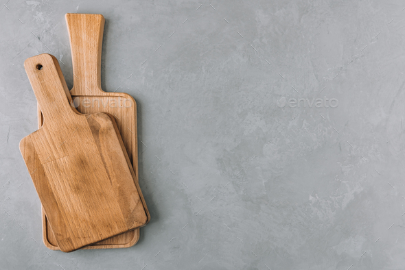 Chopping boards. Empty wooden cutting boards on gray stone background - Stock Photo - Images