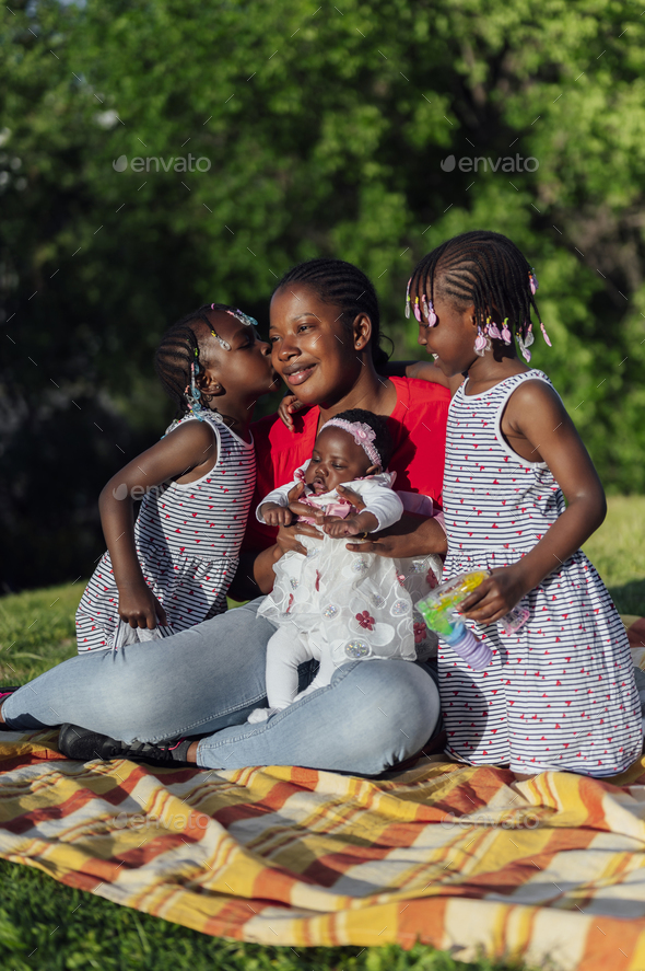 African family kissing in the park - Stock Photo - Images