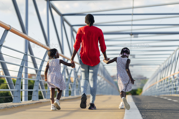 Black woman walking with her daughters - Stock Photo - Images