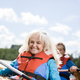 Happy senior active couple kayaking on lake - PhotoDune Item for Sale