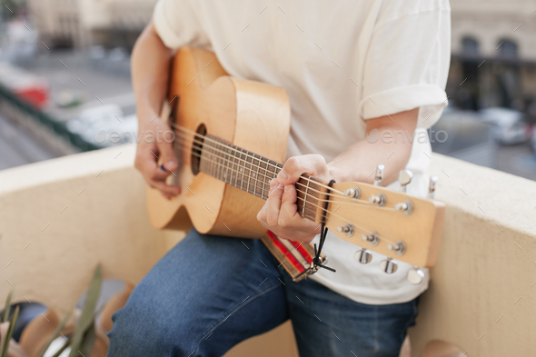 hands holding guitar and playing music - Stock Photo - Images