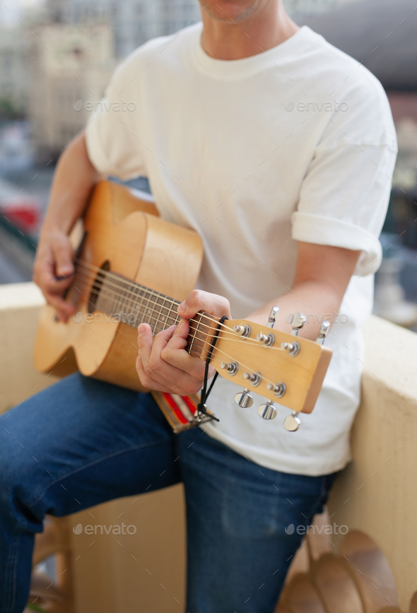 acoustic guitar in musician's hands - Stock Photo - Images