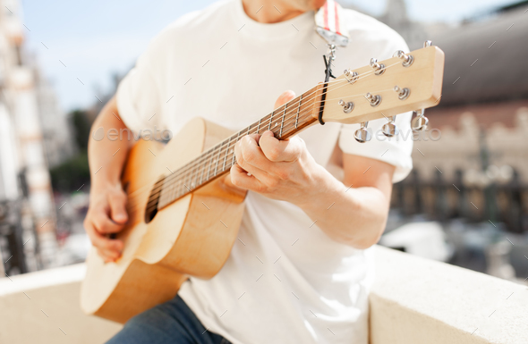 acoustic guitar in guy's hands - Stock Photo - Images