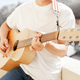 acoustic guitar in guitarist&#39;s hands. Guy holding guitar closeup - PhotoDune Item for Sale