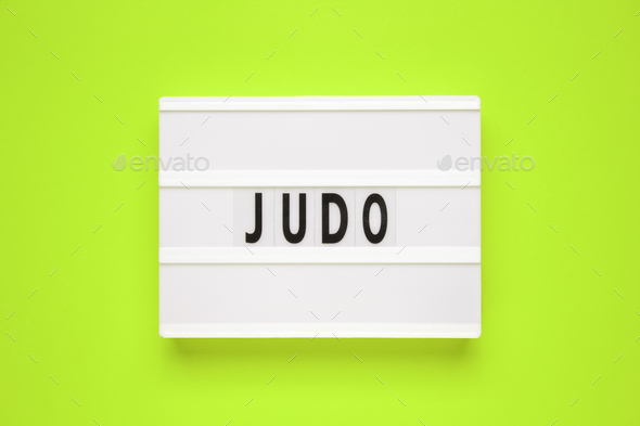 The word judo on lightbox isolated green background.