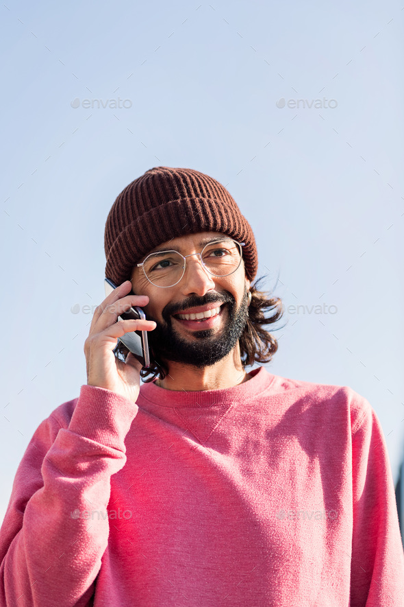 stylish young man talking on smart phone - Stock Photo - Images