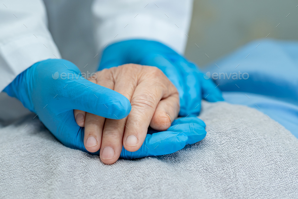 Doctor holding touching hands Asian senior woman patient with love. - Stock Photo - Images