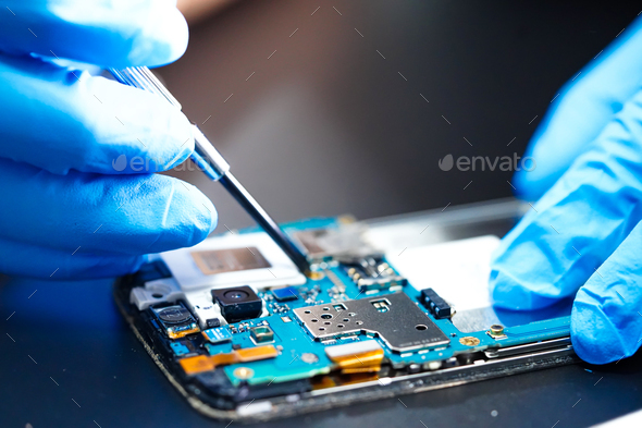 Asian Technician repairing micro circuit main board of smartphone electronic technology. - Stock Photo - Images