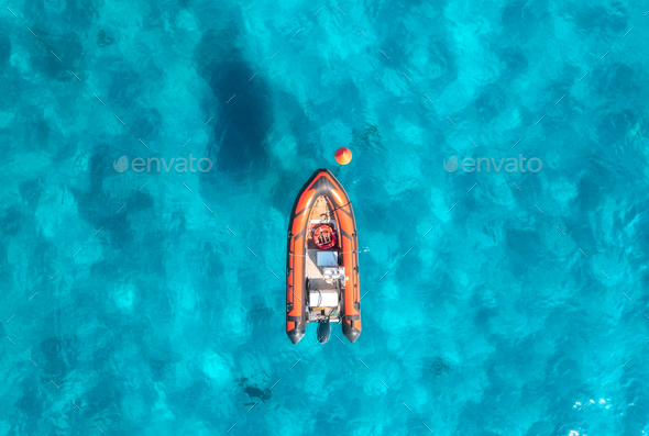 Aerial view of beautiful orange boat in blue sea at sunset - Stock Photo - Images