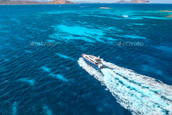 Aerial view of fast floating yacht on blue sea at sunny day - Stock Photo - Images