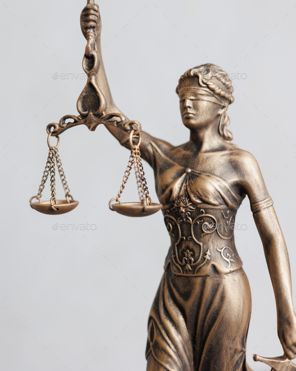 close-up themis is goddess of justice statuette on dark background. symbol of law with scales  - Stock Photo - Images