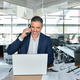 Smiling mature business man talking on cell phone using laptop in office. - PhotoDune Item for Sale
