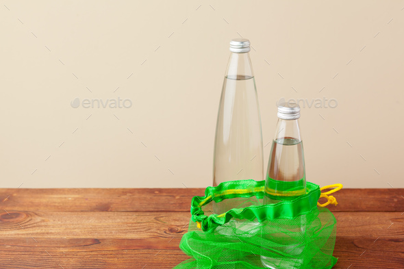 Mesh bags with reusable glass water bottle. Sustainable lifestyle. Zero  waste concept. No plastic. Stock Photo by FabrikaPhoto