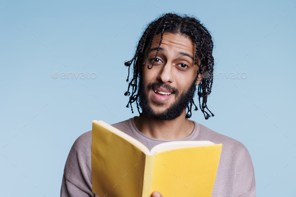 Man holding book and talking about novel plot portrait