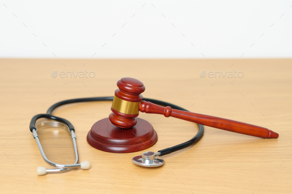 Gavel and stethoscope on table. Medical and Health Law, legal of medical malpractice concept