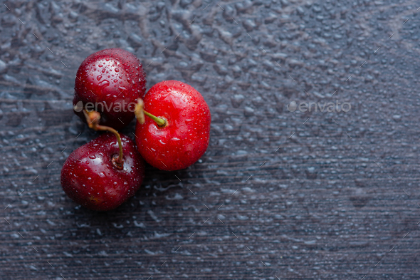 Ripe cherries on a dark wooden background. - Stock Photo - Images