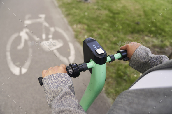 Close up of push scooter ridden by unrecognizable person on bicycle lane - Stock Photo - Images