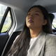 Chinese business woman driving in the car as a passenger with eyes closed - PhotoDune Item for Sale