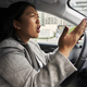 Frustrated Chinese woman screaming while driving a car - PhotoDune Item for Sale