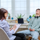 Young guy age 18-20 at therapy meeting with female psychologist, therapist - PhotoDune Item for Sale