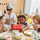 Birthday party with little black girl opening presents - PhotoDune Item for Sale