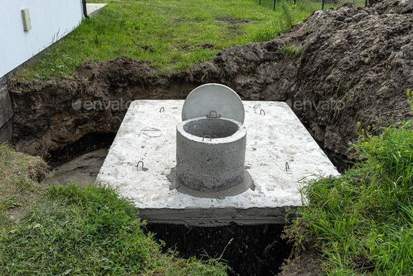 Concrete septic tank with a capacity of 10 cubic meters placed in the garden by the house. - Stock Photo - Images