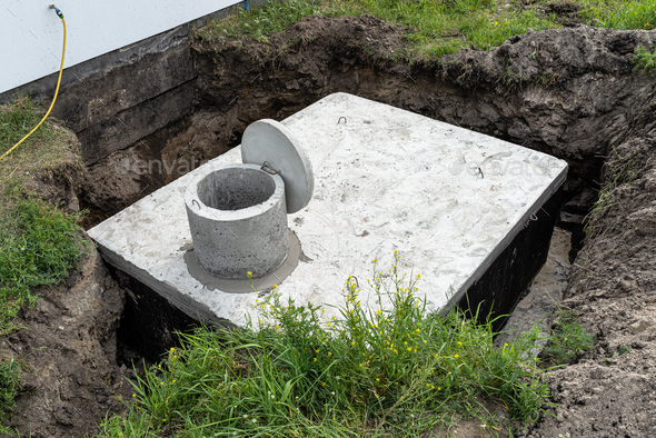 Concrete septic tank with a capacity of 10 cubic meters placed in the garden by the house. - Stock Photo - Images