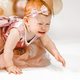 Little crying unhappy redhead baby girl celebrates first birthday anniversary. 1 year family party  - PhotoDune Item for Sale