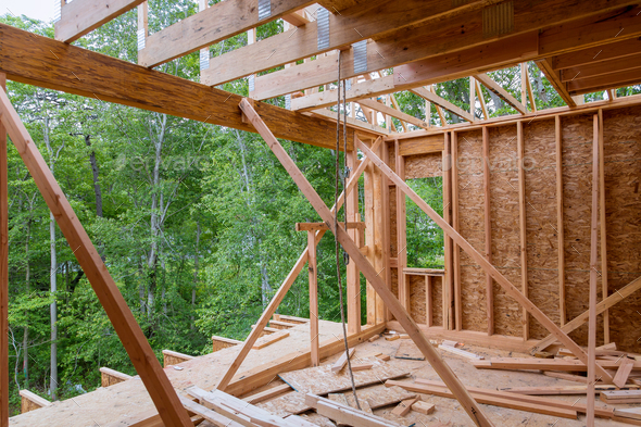 The newly constructed stick house is made of timber beams and truss frames. - Stock Photo - Images
