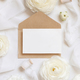 Blank card and envelope near cream roses and white ribbons top view, wedding mockup - PhotoDune Item for Sale