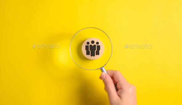 People icon on wooden block with magnifying glass, Job recruiting