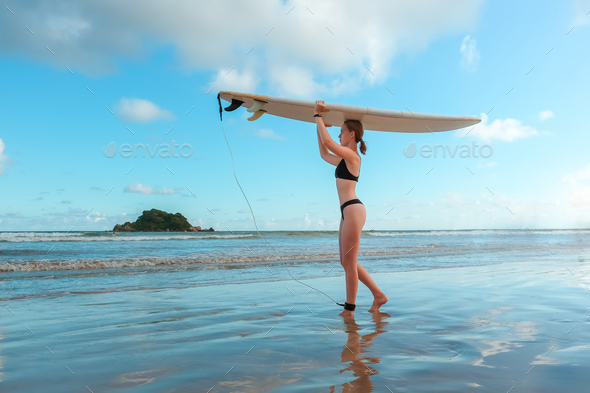 Surfing, Girl surfer with a longboard on the beach of Weligama, Indian Ocean Active water sports, tr - Stock Photo - Images