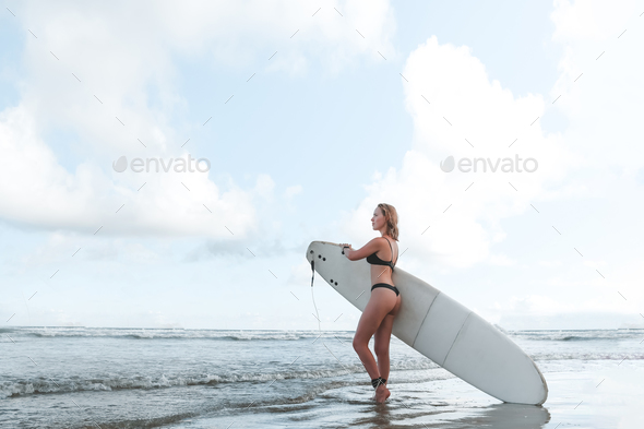 Surfing, Girl surfer with a longboard on the beach of Weligama, Indian Ocean Active water sports, tr - Stock Photo - Images