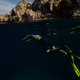 Unrecognizable man swimming underwater in mountainous bay - PhotoDune Item for Sale