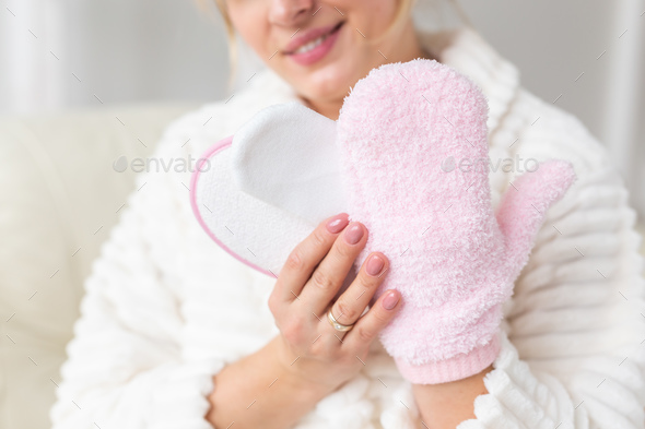 Excited joyful young woman wrapped head in towel holding dry brush shower sponge and doing spa - Stock Photo - Images